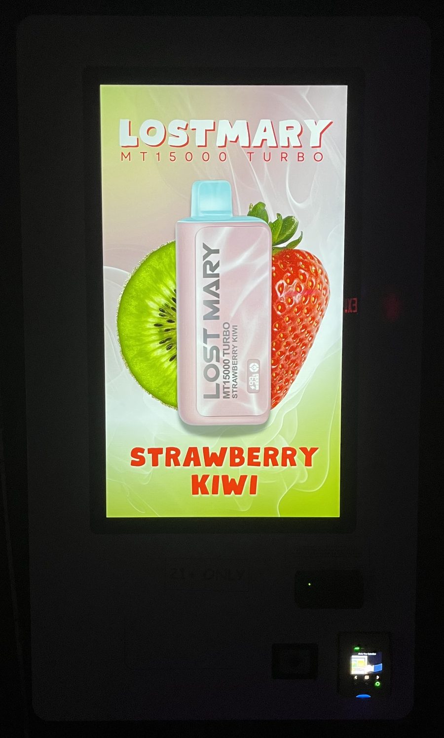 Machine screen glowing in a dark venue with a colorful product advertisement